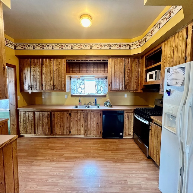 kitchen with sink, white appliances, and light wood-type flooring