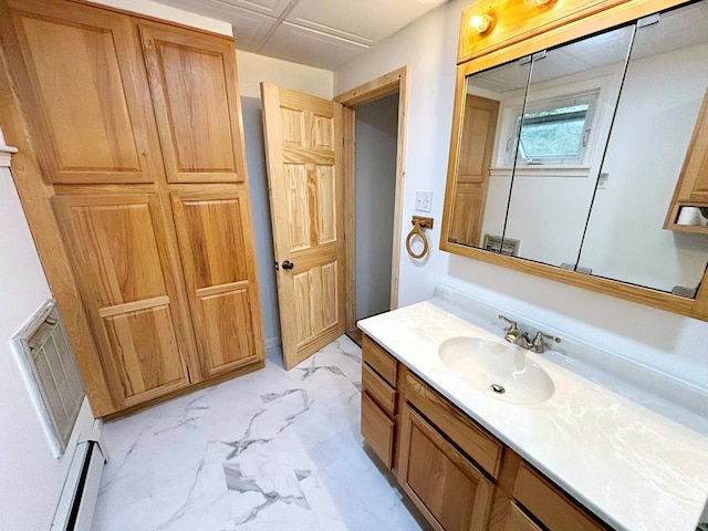 bathroom with baseboard heating and vanity