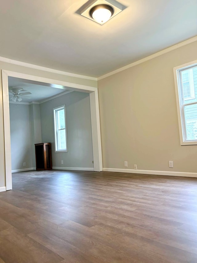 empty room featuring hardwood / wood-style flooring, ceiling fan, and crown molding