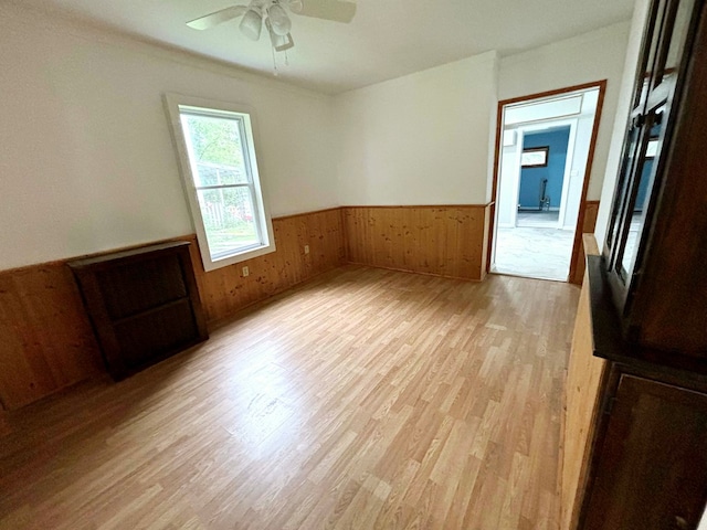 unfurnished room with ceiling fan and light wood-type flooring