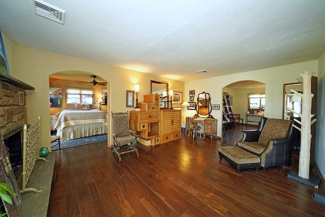 bedroom with dark hardwood / wood-style floors and a fireplace