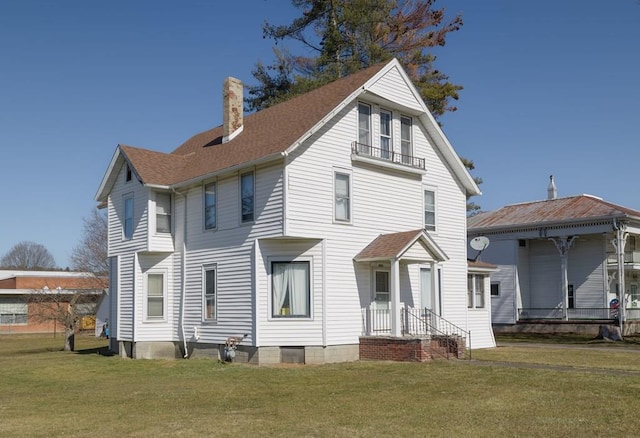 back of house featuring a yard