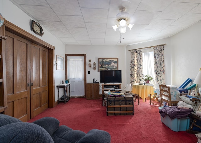 carpeted living room with wood walls