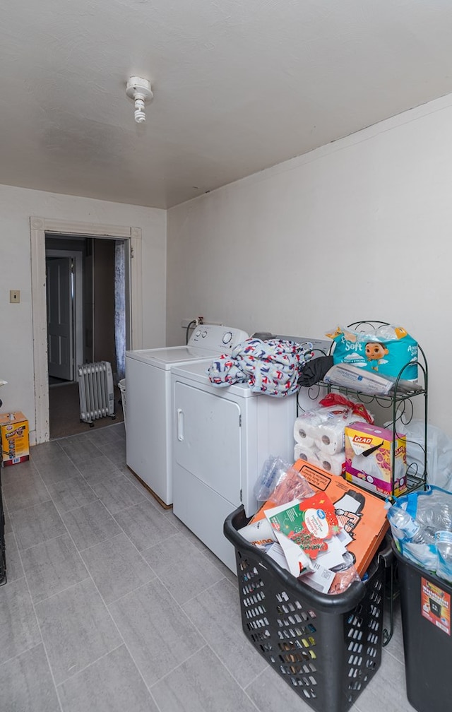 laundry area with radiator heating unit and washing machine and dryer