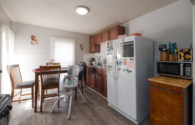 kitchen with dark wood-type flooring, stainless steel appliances, and sink