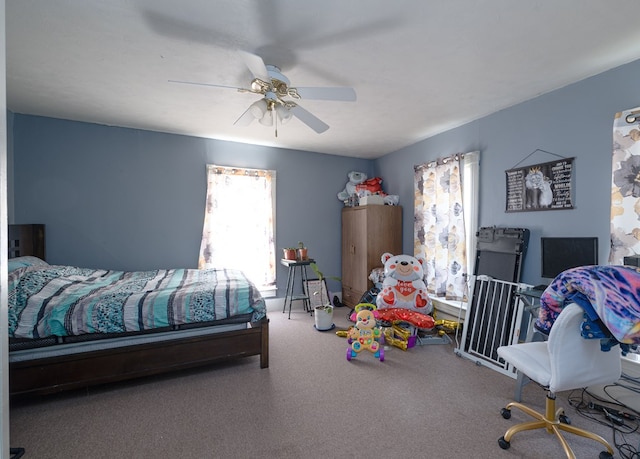 bedroom with multiple windows, ceiling fan, and carpet floors