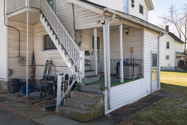 property entrance with a lawn