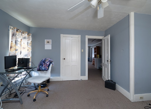 carpeted office space with ceiling fan and a textured ceiling