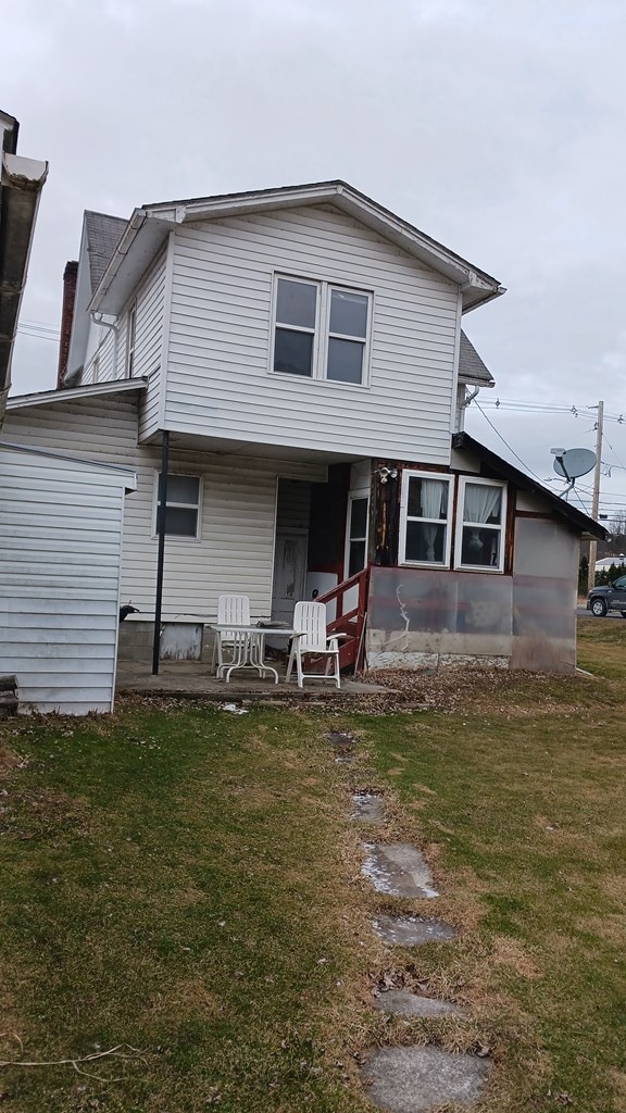 rear view of house with a lawn