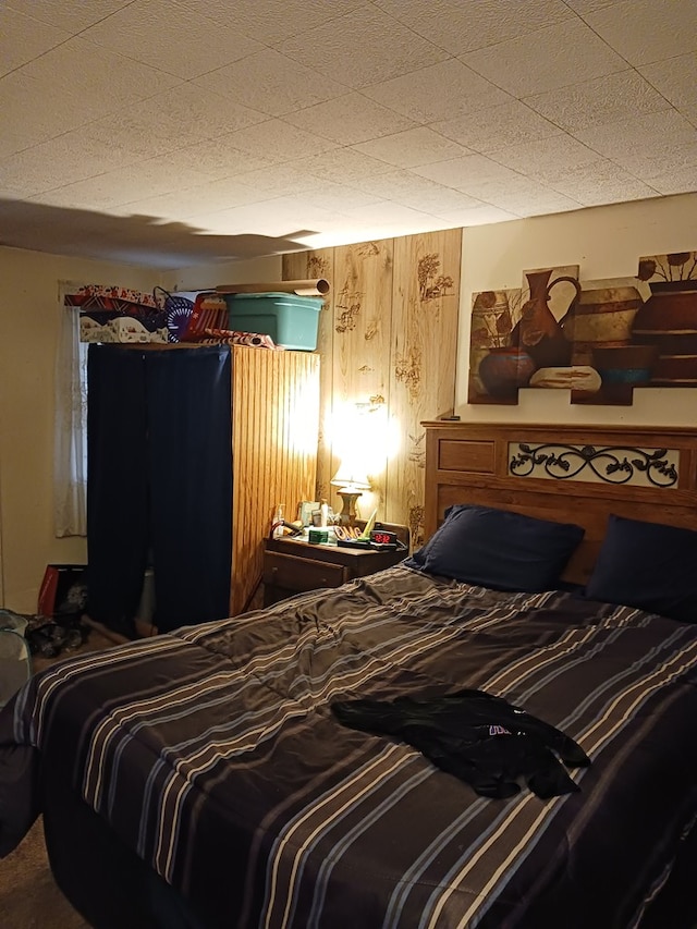 bedroom with wood walls