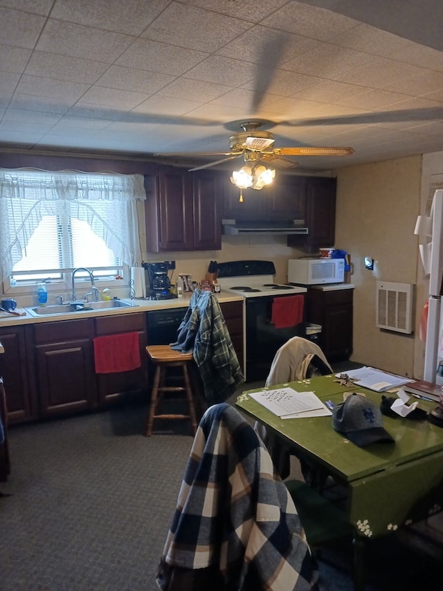 kitchen with electric stove, sink, dark brown cabinets, and extractor fan