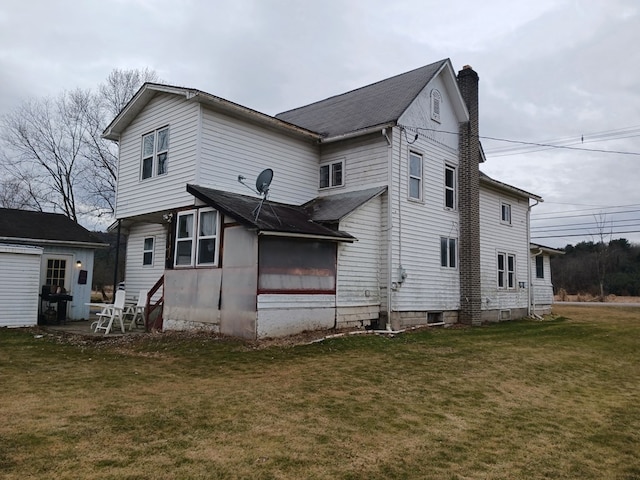 back of house with a lawn