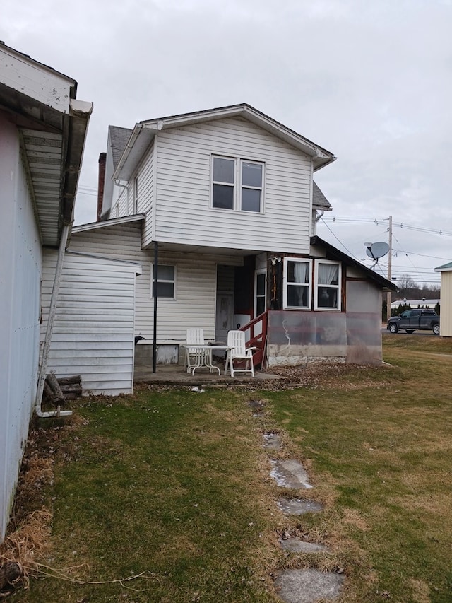 rear view of house with a yard