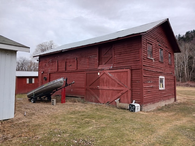 view of outbuilding featuring a yard