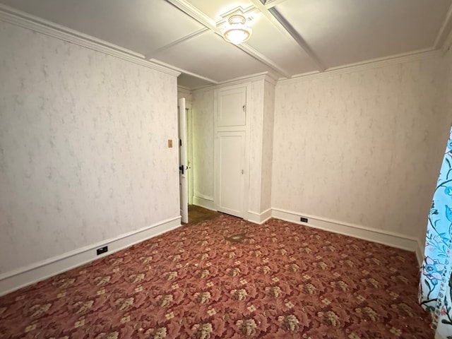 empty room with baseboards, carpet flooring, and crown molding