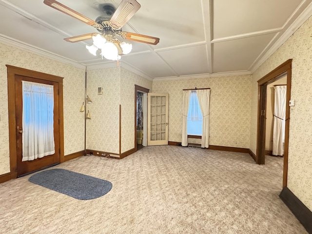 carpeted empty room with wallpapered walls, baseboards, a ceiling fan, and ornamental molding