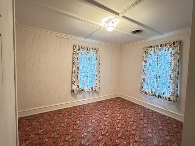 spare room featuring baseboards, visible vents, and crown molding