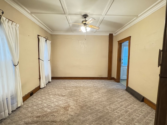 carpeted empty room with crown molding, baseboards, and ceiling fan