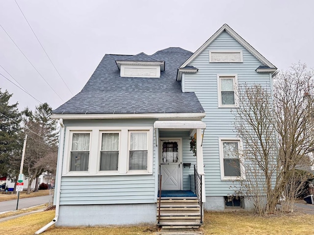 view of front facade featuring roof with shingles