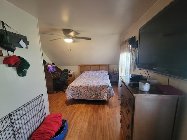 bedroom featuring vaulted ceiling, ceiling fan, and hardwood / wood-style floors