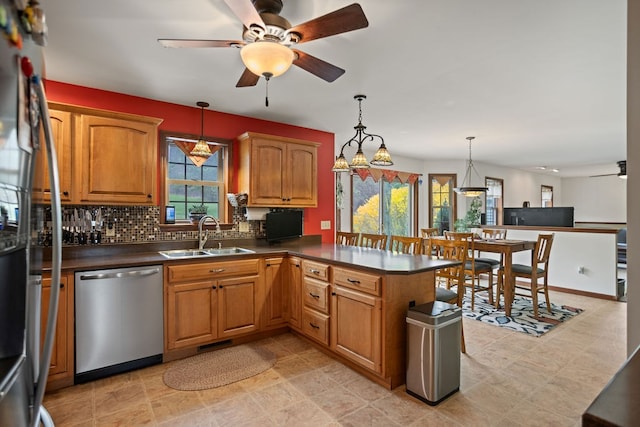 kitchen with a wealth of natural light, a ceiling fan, stainless steel dishwasher, and a sink