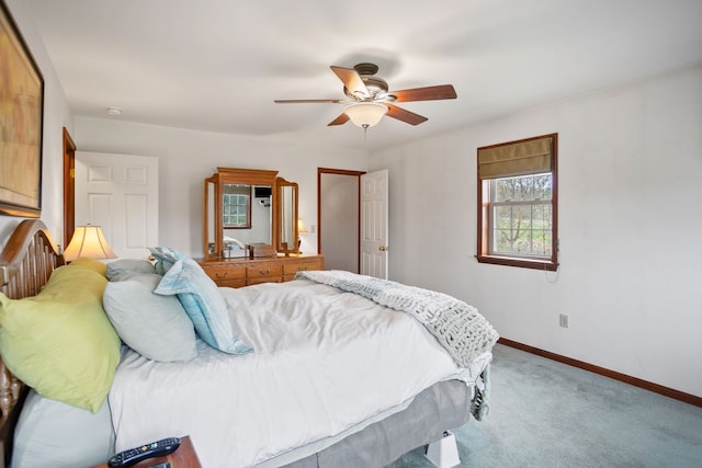 carpeted bedroom with a ceiling fan and baseboards