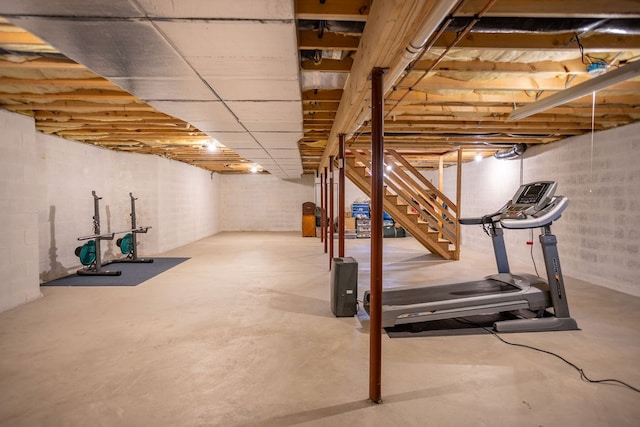 unfinished basement featuring stairs