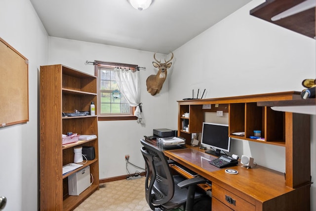 office with baseboards and light floors