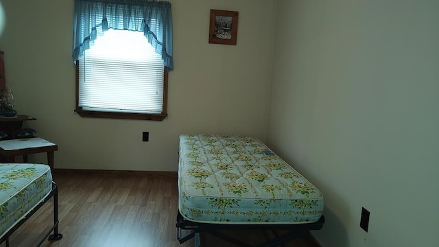 bedroom with hardwood / wood-style flooring