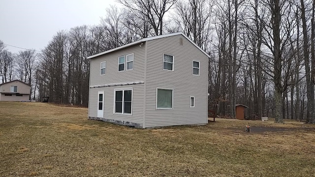 view of property exterior with a yard and a shed