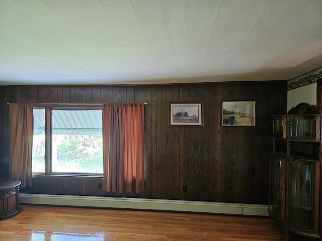 71 Kendrick Rd, Covington, PA 16917 - living area with baseboard heating, wood walls, and wood finished floors