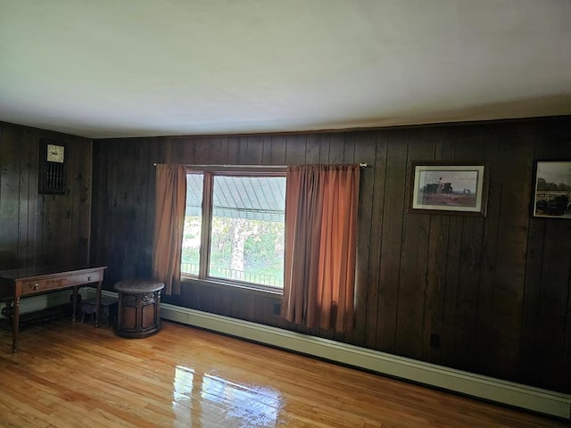 71 Kendrick Rd, Covington, PA 16917 - empty room featuring a baseboard radiator, wood walls, and wood finished floors