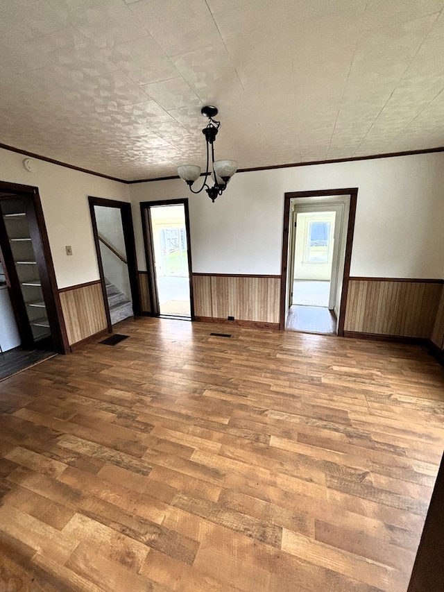 interior space with a textured ceiling, hardwood / wood-style flooring, plenty of natural light, and a notable chandelier