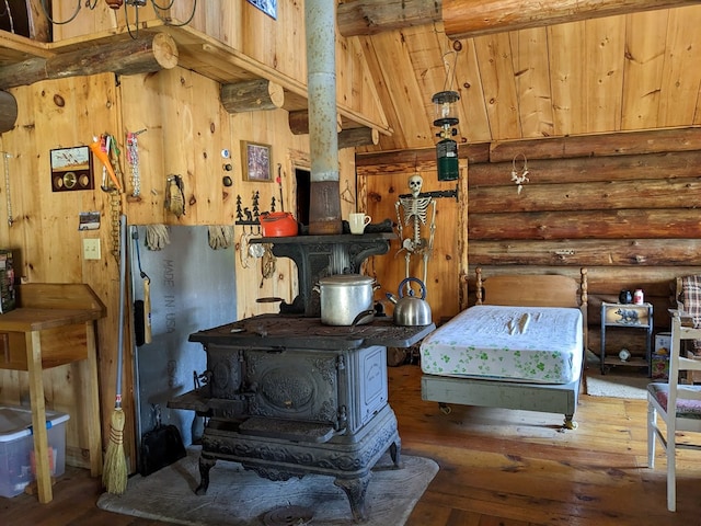 480 Bowers Rd, Coudersport, PA 16915 - bedroom featuring rustic walls, hardwood / wood-style flooring, a wood stove, and wood ceiling