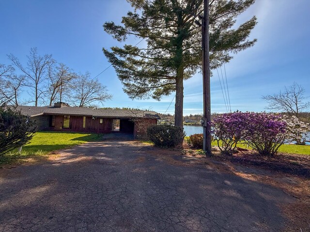 986 Wesauking Dr, Towanda, PA 18848 - ranch-style home with driveway, a chimney, a front lawn, and a carport