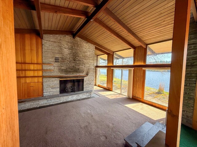 986 Wesauking Dr, Towanda, PA 18848 - unfurnished living room featuring a fireplace, carpet flooring, a water view, beamed ceiling, and high vaulted ceiling