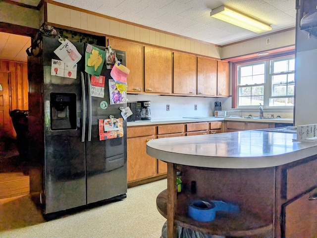 1057 Stony Fork Rd, Wellsboro, PA 16901 - kitchen with brown cabinets, a sink, light countertops, black refrigerator with ice dispenser, and ornamental molding