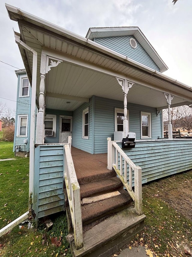 223 Lombard St, Towanda, PA 18848 - view of front of house featuring covered porch and a front yard