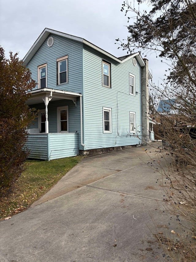 223 Lombard St, Towanda, PA 18848 - view of front of house with a chimney and covered porch
