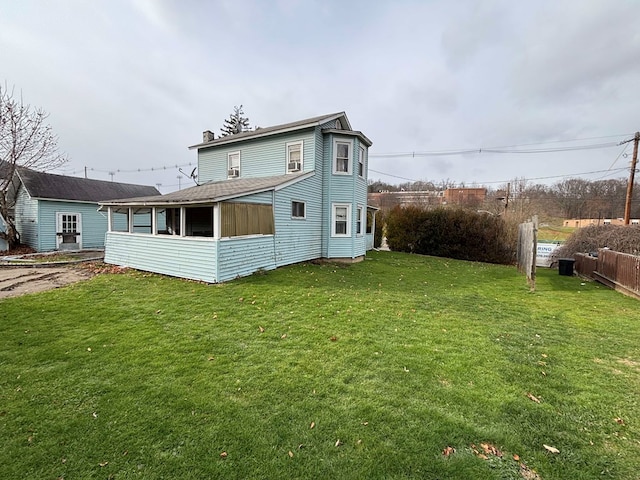 223 Lombard St, Towanda, PA 18848 - rear view of property featuring a chimney and a sunroom