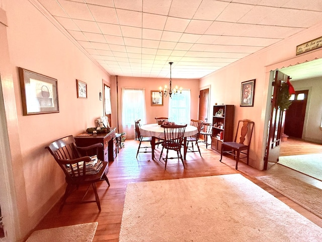 10598 Leetonia Rd, Gaines, PA 16921 - dining space featuring wood finished floors, a chandelier, and crown molding