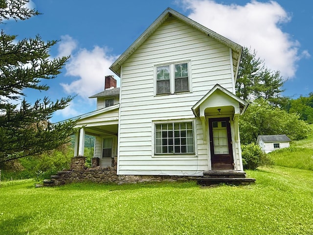 10598 Leetonia Rd, Gaines, PA 16921 - rear view of house featuring a lawn and a chimney