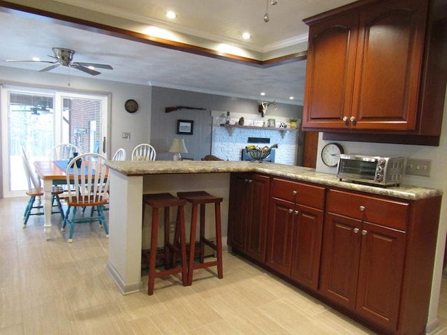 kitchen with ceiling fan, ornamental molding, and backsplash