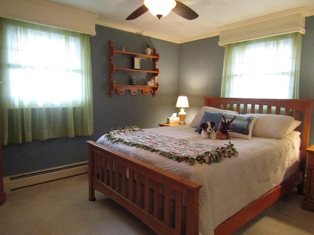 carpeted bedroom featuring a baseboard heating unit, crown molding, and ceiling fan