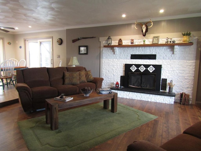 living room with ceiling fan, ornamental molding, and wood-type flooring