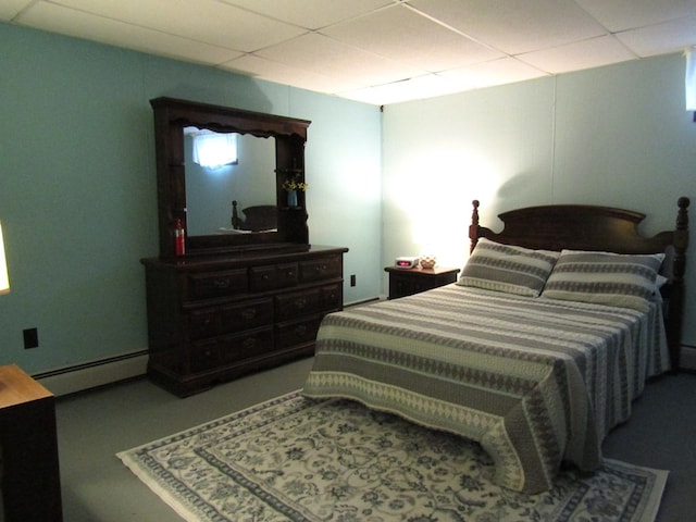 bedroom featuring a paneled ceiling and baseboard heating