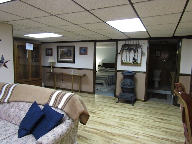 basement featuring hardwood / wood-style flooring and a drop ceiling