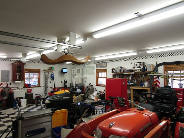 garage with electric panel and a workshop area