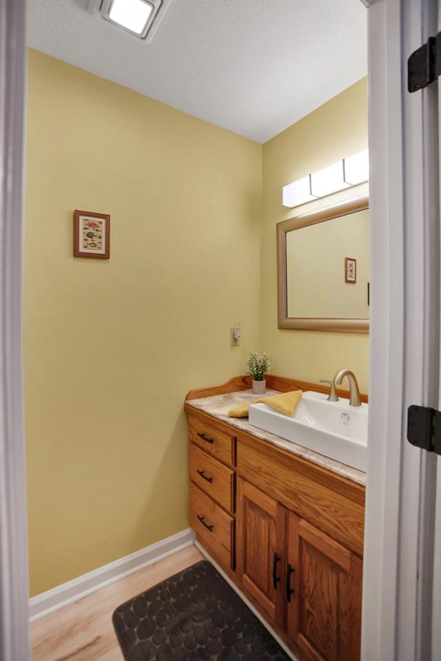 bathroom featuring vanity and wood-type flooring