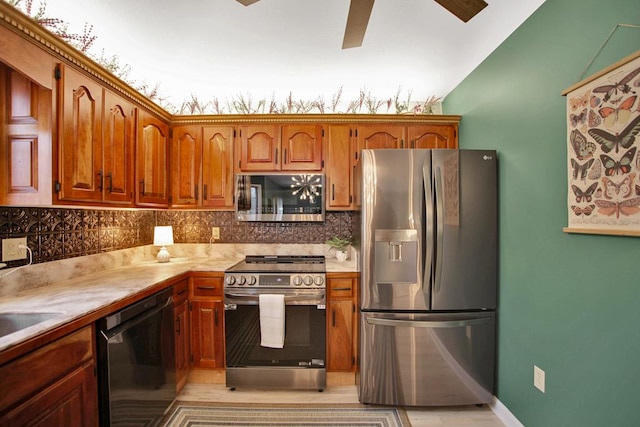 kitchen featuring backsplash, lofted ceiling, and appliances with stainless steel finishes